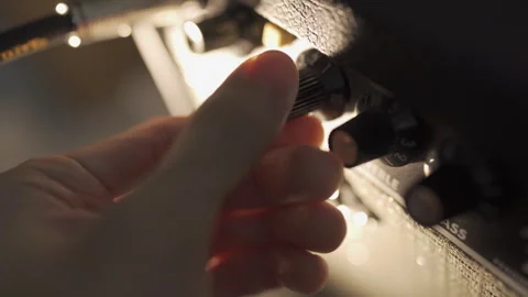 Adjusting tone and volume knobs on a guitar amplifier Video stock 247049135