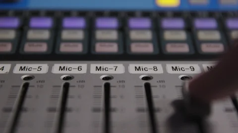 Adjusting the track audio level fader on an audio mixing board Stock Footage 89502179