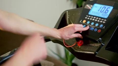 Adjusting treadmill program during active running session on home fitness 動画素材 331207578