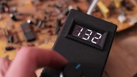 Adjusting Voltage Regulator Knob Decreasing Digital Display Reading 库存影片 306237639