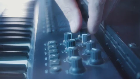Adjusting the volume of the channels on the MIDI keyboard close-up 4k Stock Footage 97642877