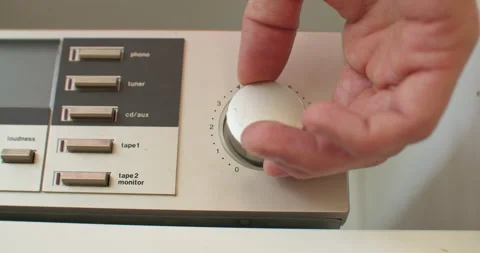 Adjusting the volume knob of an old stereo in small increments. Checking Stock Footage 235662351