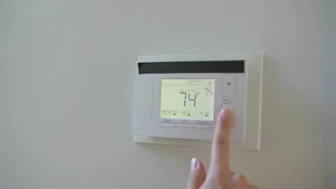 Adjusting wall thermostat change temperature Stock Footage 319920807