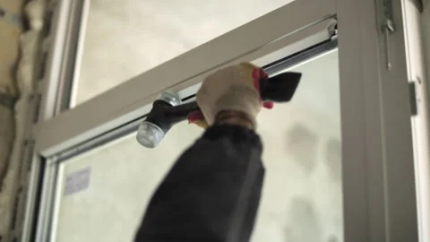 Adjusting window glass inside frame with rubber mallet Stock Footage 327290398