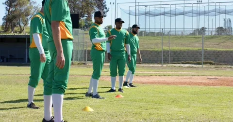 Adjusting yellow cone sparking side stepping, sprinting by diverse male baseball Stock Footage 335513552