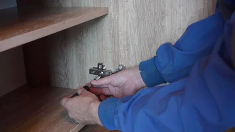 Adjustment of the hinges in the cabinet Stock Footage 279380534