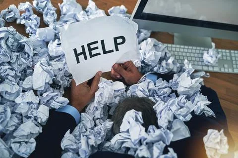 Admin can get the better of anyone. Shot of an unidentifiable businessman ask Stock Photos