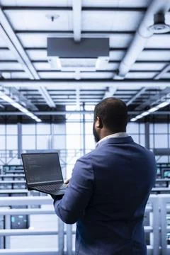 Admin in data center checking rigs and hardware, doing checkup Stock Photos