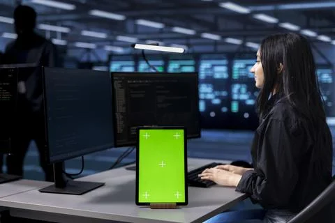Admin in data center running system diagnostic tests using green screen tablet Stock Photos