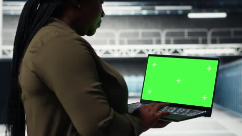 Admin in data center uses green screen laptop to ensure error free networks Stock Footage 317124075