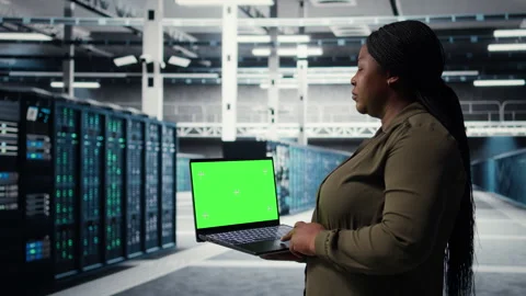 Admin in data center uses green screen laptop to ensure error free networks Stock Footage 317124419