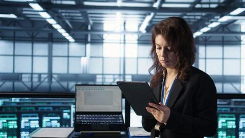 Admin in data center using artificial intelligence tech on tablet 스톡 사진