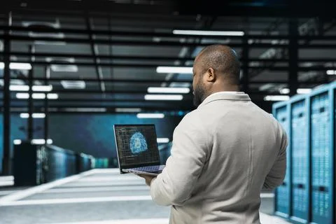 Admin in data center using artificial intelligence simulating human brain Stock Photos