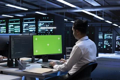 Admin in data center using diagnostic tools on green screen PC Stock Photos
