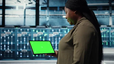Admin in data center using green screen tablet to deploy new server architecture Stock Footage 317123031