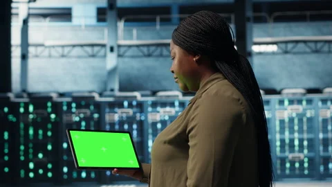 Admin in data center using green screen tablet to deploy new server architecture Stock Footage 317204654
