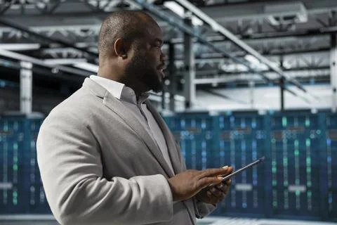 Admin in data center using tablet, reading error logs, doing checkup Stock Photos
