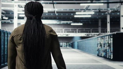 Admin in data center workplace overseeing large scale IT electronics Stock Footage 317124928