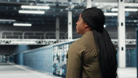 Admin in data center workplace overseeing large scale IT electronics Stock Footage 317124975