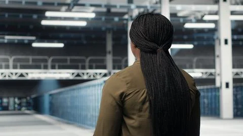 Admin in data center workplace overseeing large scale IT electronics Stock Photos