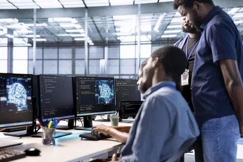 Admin doing brainstorming with colleagues in server farm, using AI Foto stock