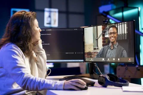 Admin doing company software debugging, talking with management in videocall 스톡 사진