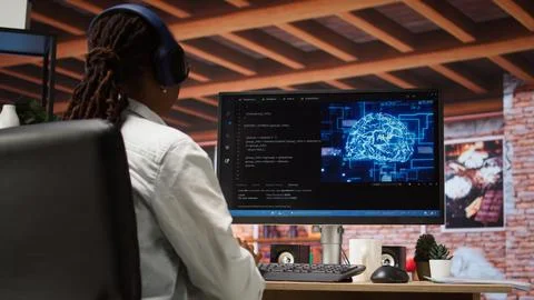 Admin doing maintenance on artificial intelligence, listening music Stock Photos