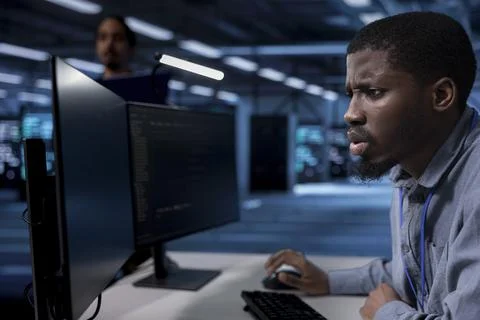 Admin frowning after seeing error in server farm supercomputers 写真素材