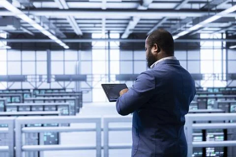 Admin in high tech data center making sure rackmounts are functioning Stock Photos