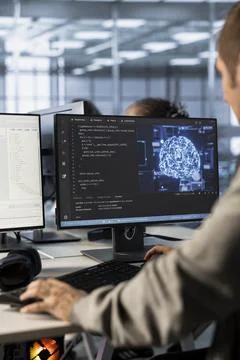 Admin implementing artificial intelligence cybersecurity measures in data center Stock Photos