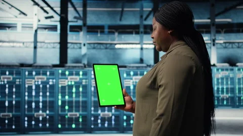 Admin with isolated screen tablet in data center doing power management Stock Footage 317125334