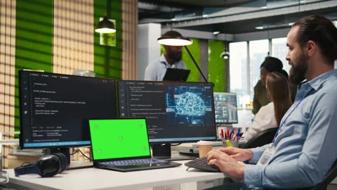 Admin in office uses isolated screen laptop, automating repetitive tasks with AI Stock Footage 313016250