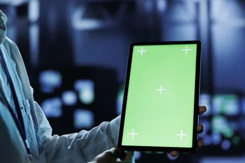 Admin runs code on chrome key tablet Stock Photos