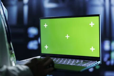 Admin runs code on green screen laptop Stock Photos