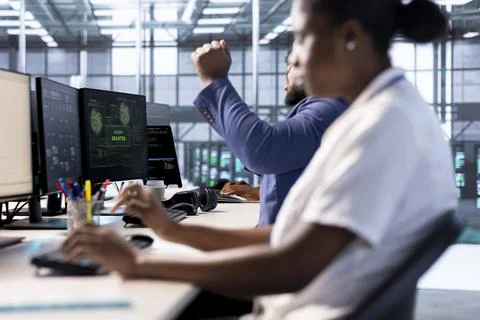 Admin in server farm celebrating after getting access granted, Foto stock