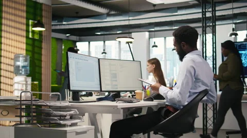 Admin in tech startup office using PC, compiling software patches to fix bugs Stock Footage 313017176