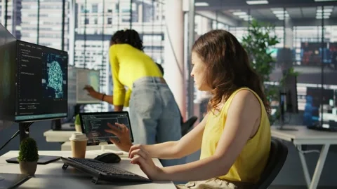 Admin tests on computer and tablet to optimize artificial intelligence tech Stock Footage 318236493