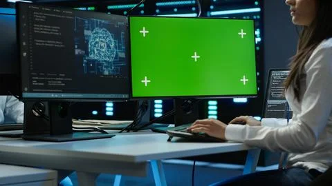 Admin using AI tech on isolated screen PC to do maintenance in server room 写真素材