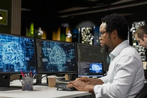 Admin using computer in tech startup office to develop programs using AI Foto stock