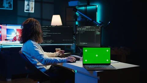 Admin using green screen laptop to implement security measures Stock Photos