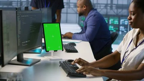 Admin using isolated screen tablet, working in server farm Stock Photos