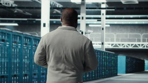 Admin walking in data center, doing inspection on infrastructure tech Stock Footage 311832914