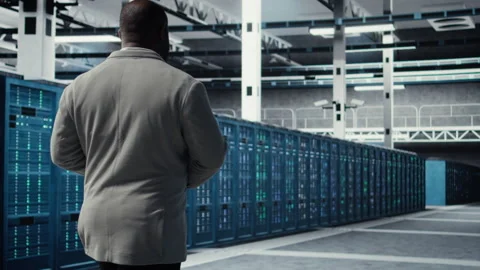 Admin walking in data center, doing inspection on infrastructure tech Stock Footage 311833149