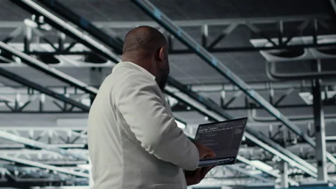 Admin walking in data center industrial platform, analyzing performance Stock Footage 311833011