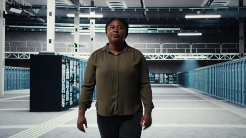 Admin walking in data center, overseeing large scale IT infrastructure Stock Footage 317123163