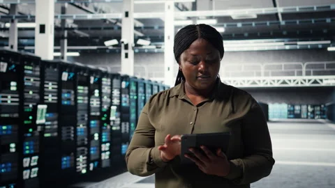 Admin walking in data center, using tablet to manage software updates Stock Footage 317204284