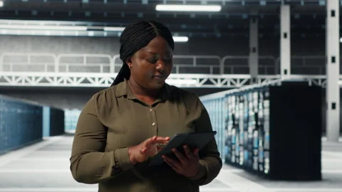 Admin walking in data center, using tablet to manage software updates Stock Footage 317204413