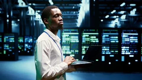 Admin walking through server rackmounts 写真素材