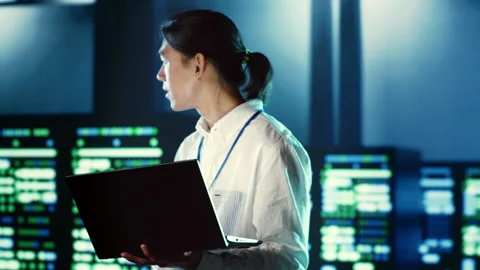 Admin walks through data center systems Stock Footage 250293066