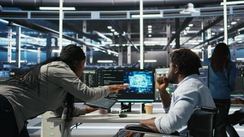 Admin in wheelchair and data center coworker work together using node tree tool Stock Footage 307039038